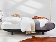 black wooden floating platform bed side view