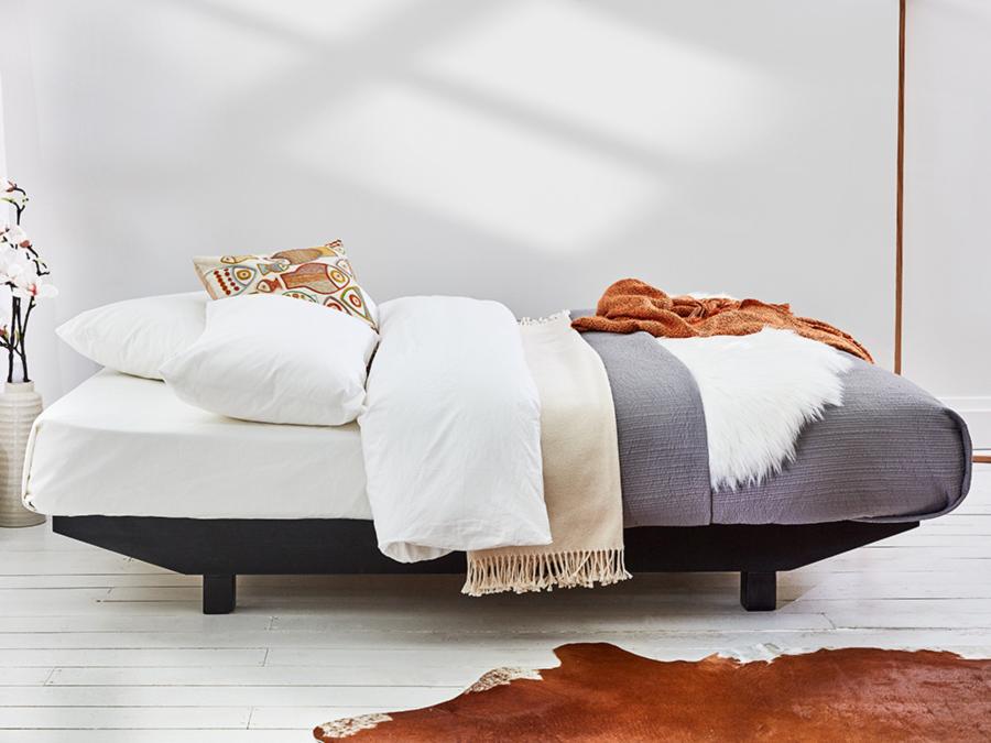 black wooden floating platform bed side view