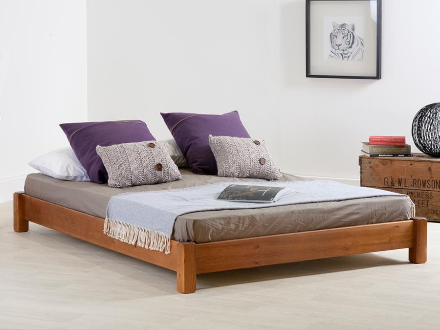 low wooden platform bed without headboard